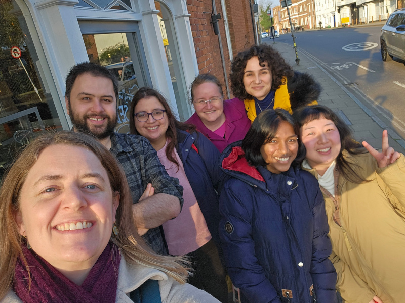 Image of Laurie and lab members celebrating viva success outside a cafe in Colchester